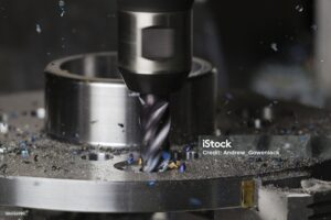 A hole is milled in a flange on a CNC machining center using a carbide endmill