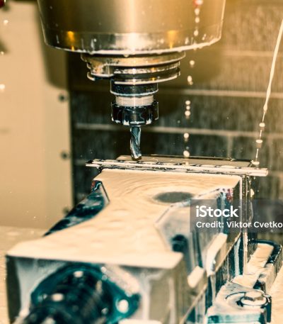 CNC milling machine with coolant at tool workshop.